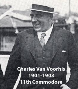 Black‑and‑white portrait of a yacht club commodore wearing a formal jacket and commodore’s cap