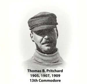 Black‑and‑white portrait of a yacht club commodore wearing a formal jacket and commodore’s cap