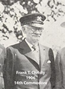 Black‑and‑white portrait of a yacht club commodore wearing a formal jacket and commodore’s cap