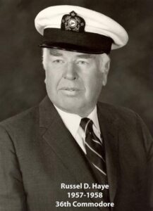 Portrait of a man in a yacht club commodore uniform with a white cap and dark jacket