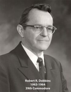 Portrait of a man in a yacht club commodore uniform with a white cap and dark jacket