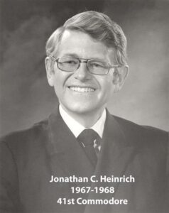 Portrait of a man in a yacht club commodore uniform with a white cap and dark jacket