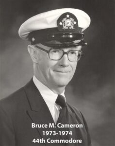 Portrait of a man in a yacht club commodore uniform with a white cap and dark jacket