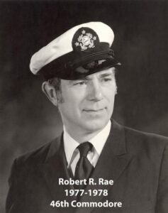 Portrait of a man in a yacht club commodore uniform with a white cap and dark jacket