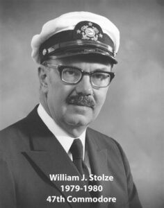 Portrait of a man in a yacht club commodore uniform with a white cap and dark jacket