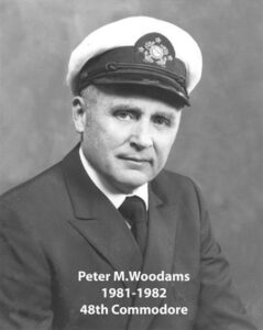 Portrait of a man in a yacht club commodore uniform with a white cap and dark jacket