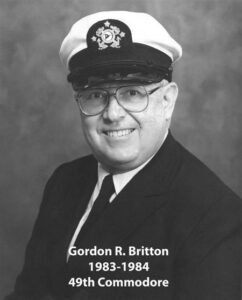Portrait of a man in a yacht club commodore uniform with a white cap and dark jacket