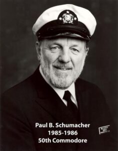 Portrait of a man in a yacht club commodore uniform with a white cap and dark jacket