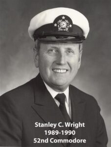 Portrait of a man in a yacht club commodore uniform with a white cap and dark jacket