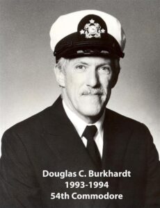 Portrait of a man in a yacht club commodore uniform with a white cap and dark jacket