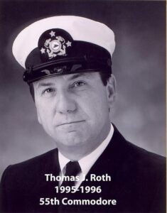 Portrait of a man in a yacht club commodore uniform with a white cap and dark jacket
