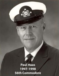 Portrait of a man in a yacht club commodore uniform with a white cap and dark jacket