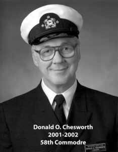 Portrait of a man in a yacht club commodore uniform with a white cap and dark jacket