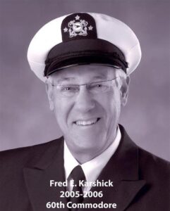 Portrait of a man in a yacht club commodore uniform with a white cap and dark jacket