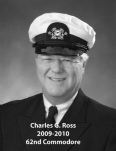 Portrait of a man in a yacht club commodore uniform with a white cap and dark jacket