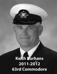 Portrait of a man in a yacht club commodore uniform with a white cap and dark jacket