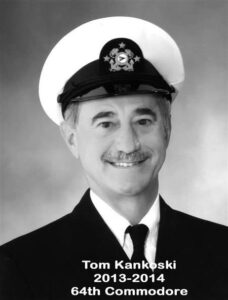 Portrait of a man in a yacht club commodore uniform with a white cap and dark jacket